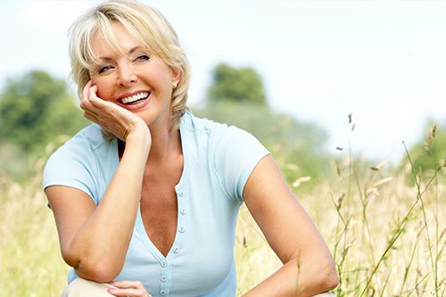 women smiling in a field